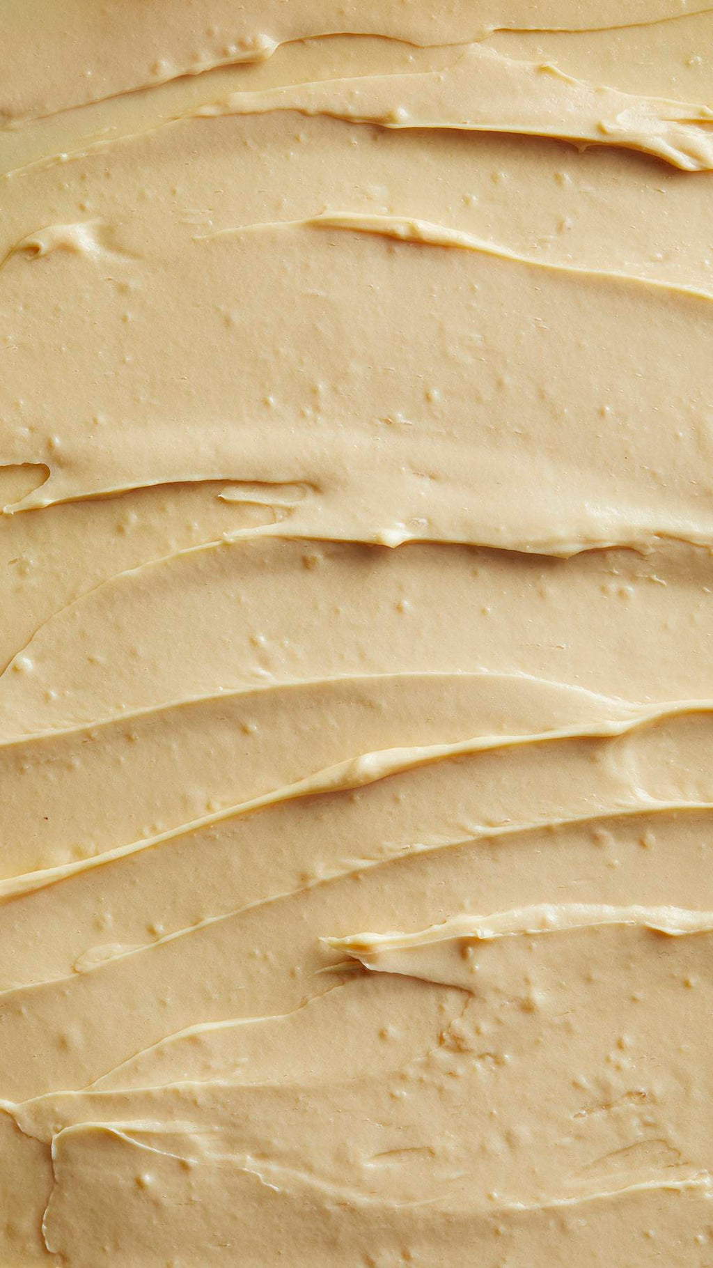 Image is a very defined close-up of the thick, pastel-yellow Tofu shampoo spread almost like a batter.